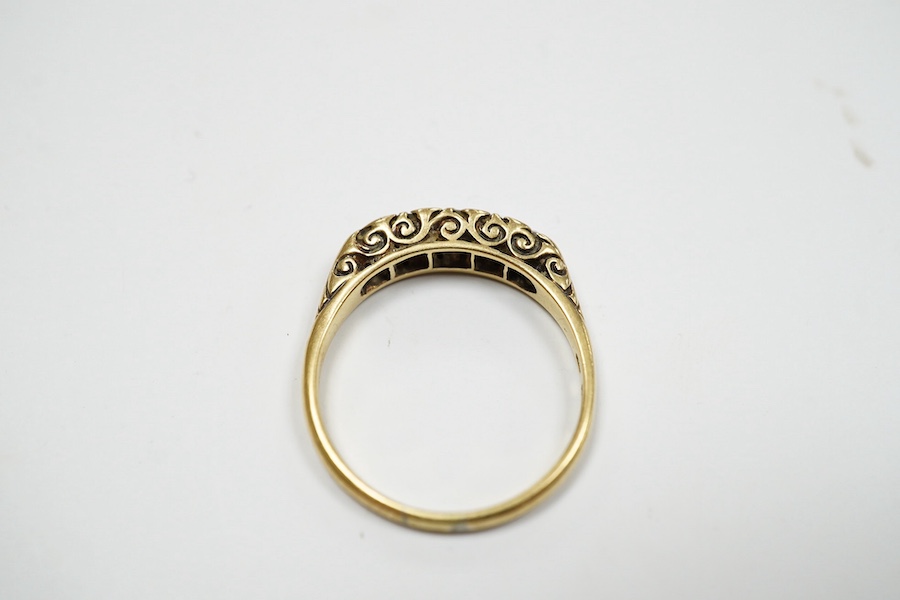 A yellow metal and graduated five stone diamond set half hoop ring, size O, gross weight 3.1 grams. Condition - fair to good